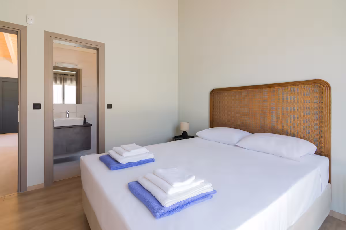 Master bedroom with double bed and stylish decor at Elegant House with Private Pool in Schinias, Greece