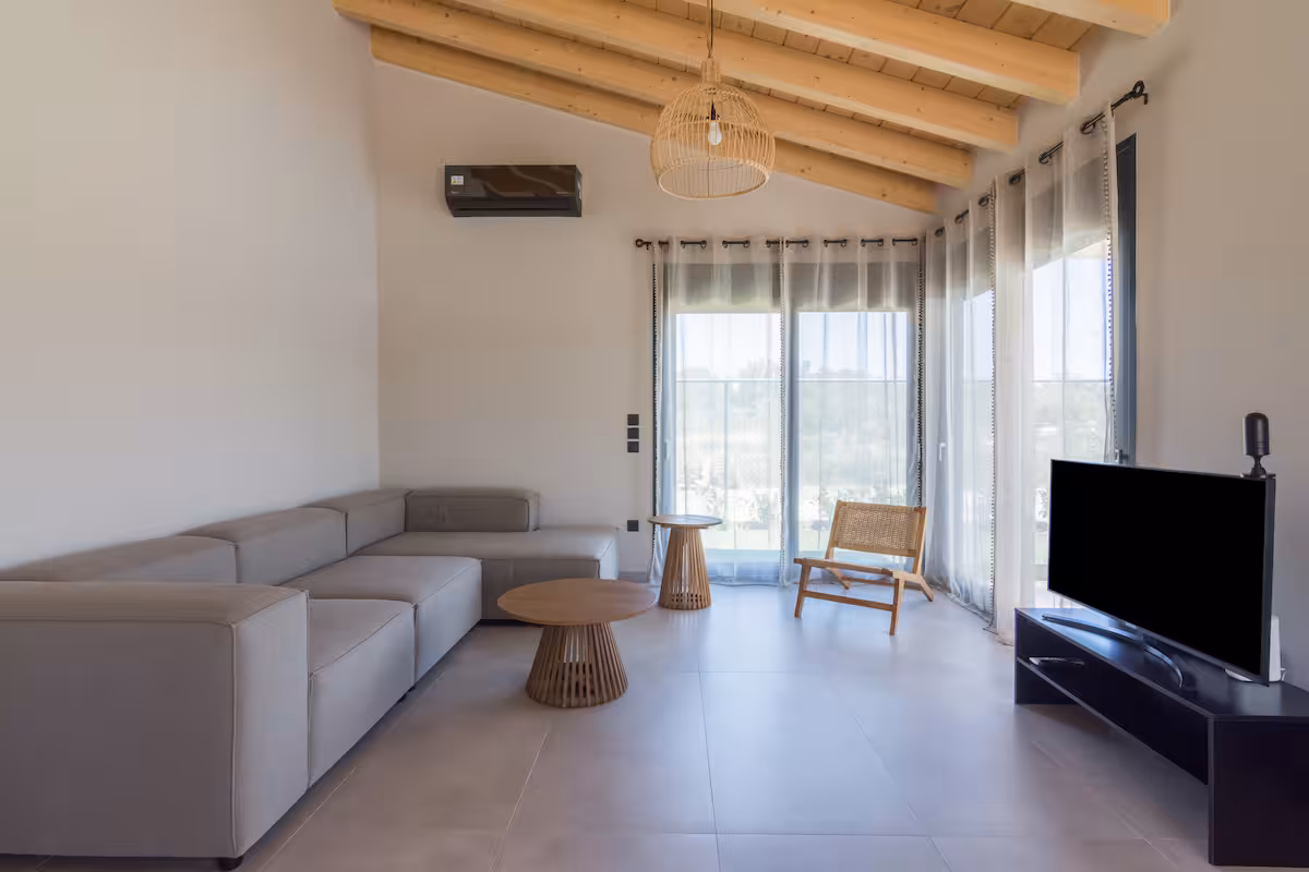 Contemporary living room with sofa bed and direct terrace access in Schinias holiday villa