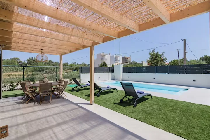 Private swimming pool with loungers and garden view in villa in Schinias, Attica